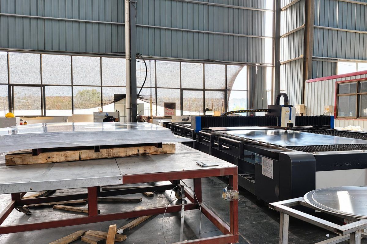 Fibre laser cutting bed with a cut aluminium sheet on the table