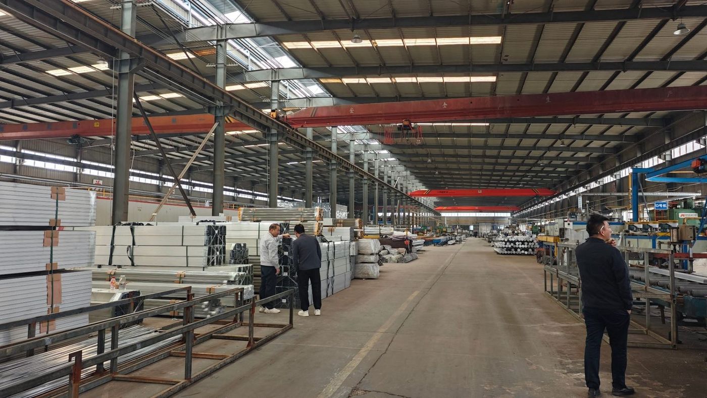 Two LUYA ALUMINUM staff reviewing orders in the warehouse